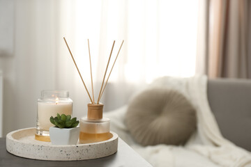 Fototapeta Air reed freshener, candle and plant on table in room, space for text obraz