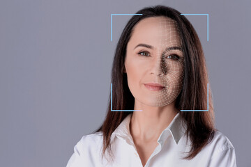 Facial recognition system. Woman with scanner frame and digital biometric grid on grey background, space for text