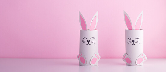 cute rabbits from a roll of toilet paper on a pink background.creative holiday background