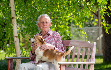 Old man with dog in garden