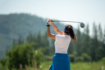 Golfer sport course golf ball fairway. People lifestyle woman playing game golf and hitting go on...