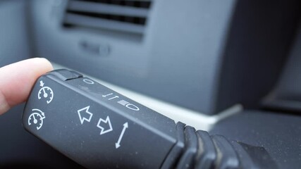 Male hands pressing the button the adaptive cruise control while driving a car