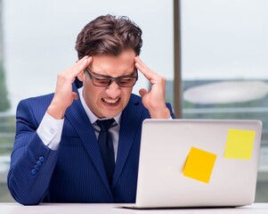 Workaholic businessman overworked with too much work in office