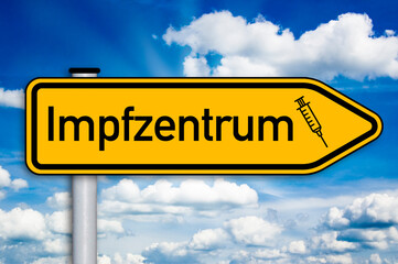 Road sign with the german word for covid-19 vaccination center or centre - impfzentrum with blue sky
