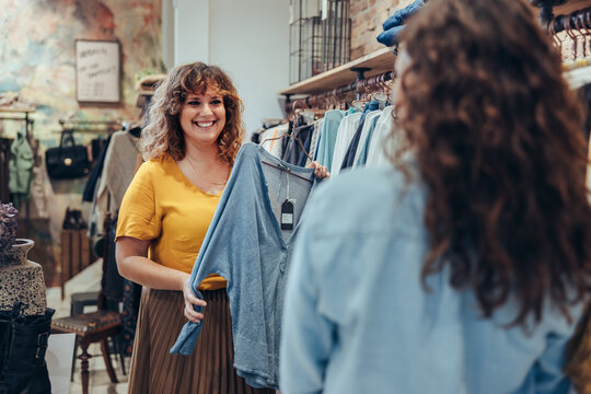 Saleswoman assisting customer in clothing store