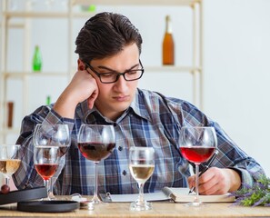 Professional sommelier tasting red wine