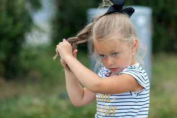 nfocused child girl blonde braids hairstyle herself a braid