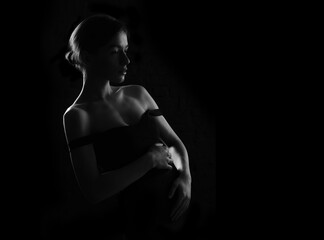 Silhouette of a pregnant woman on a dark background.