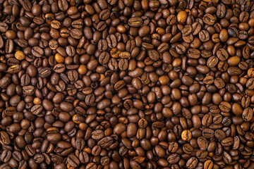 Roasted coffee beans covering the entire picture, creating a nice background.