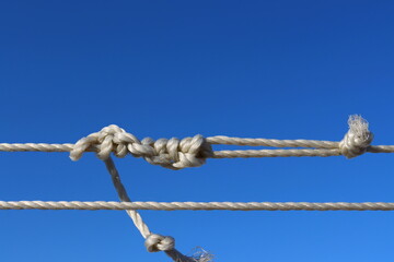White rope with knots on a blue background