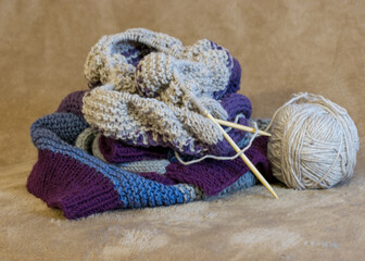 colored knitted jacket, knitting needles with yarn, handmade, wool yarn, warm knits