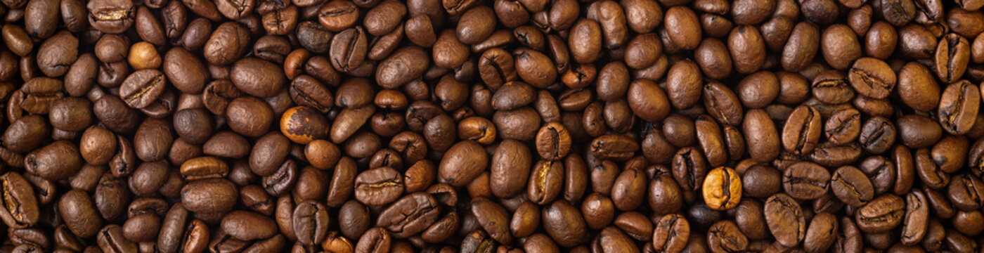Roasted coffee beans covering the entire picture, creating a nice background.