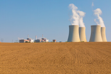 Nuclear power plant Temelin in Czech Republic Europe with plowed field.
