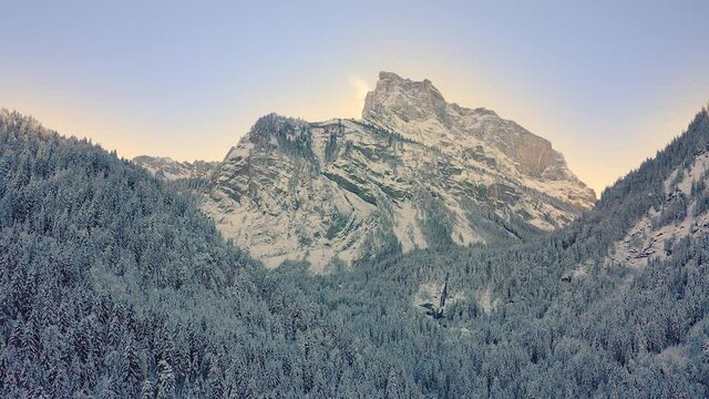 A Beautiful Aerial Rise Up over the snowy forest of the Reserve of Sixt-Fer-&agrave;-Cheval during winter, French Alps