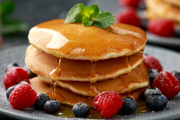 American pancakes with fresh blueberry, raspberry and honey. Healthy morning breakfast