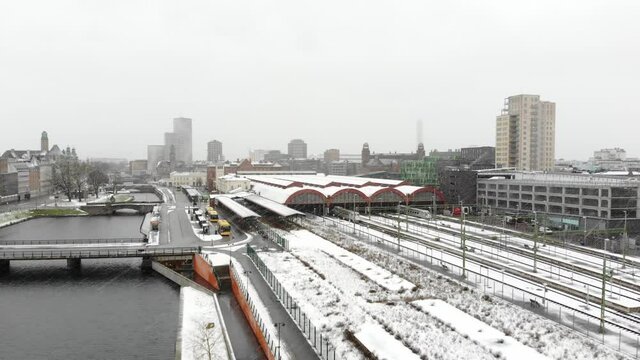 Drone flying towards Malm&ouml; Central Station in snow. Turning torso, Clarion Hotel in background