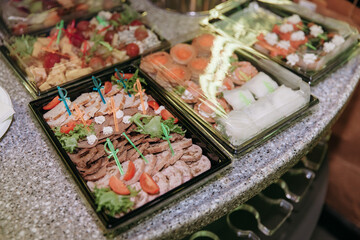 A table with snacks and food for a party in the party bass. Fruits. Sushi rolls. Wedding.