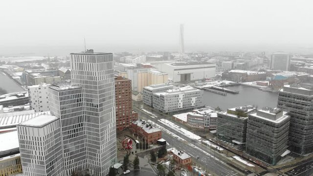 Drone flying over Malm&ouml; while it is snowing. 
Clarion hotel, turning torso, Malmo university