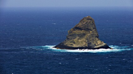 Fototapeta na wymiar remote sugar loaf island in agitated ocean