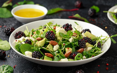 Blackberry salad with greens, almond nuts, feta, avocado and feta cheese