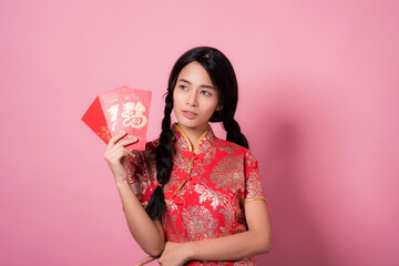 Shocked amazed Asian Chinese Woman in Cheongsam Traditional Red Dress Holding Shopping Bag and Paid Via Credit in Chinese Lunar New Year Festival