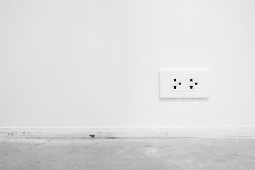 Electric Socket on White Paint Concrete Wall Background.