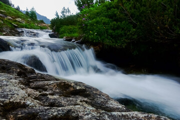Fototapeta na wymiar wild mountain creek while hiking in the summer