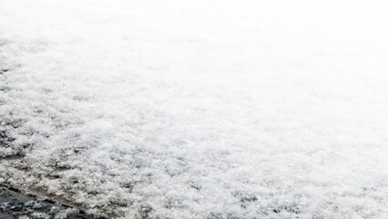 thin layer of snow on wooden background - copy space