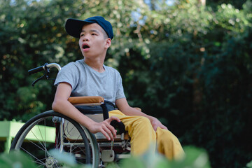 Obraz premium Asian special child on wheelchair happy on vegetable garden background,Activity in outdoor classroom with school, Life in the education age of disabled children,Happy disabled kid concept.