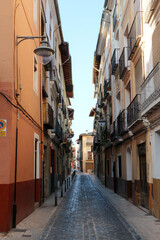 Fototapeta na wymiar cosy beautiful narrow street in old spanish town Xativa, province of Valencia