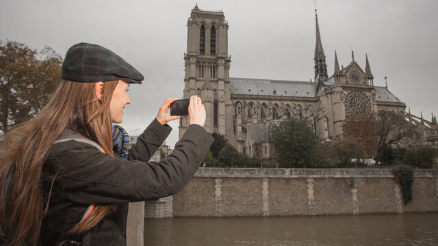 Young traveler taking photos in parisian street, paris, France