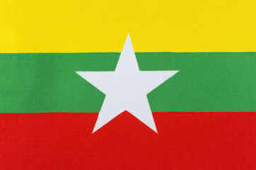 Myanmar national flag close-up on fabric base