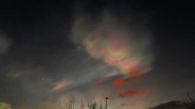 Glowing colorful nacreous clouds in the night sky - Wide