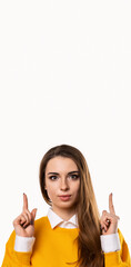 Portrait of attractive girl pointing fingers up, showing good shopping site, recommend click link,...