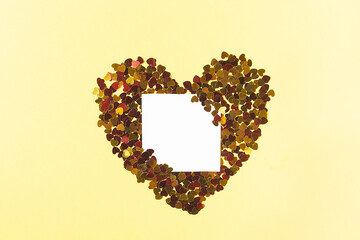 White square for notes surrounded by yellow sparkles in the form of a heart card for valentine's day