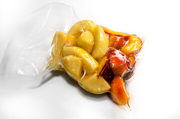 peach fruit slices  vacuum packed sealed for sous vide cooking on white background