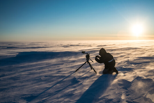 Video Camera On Tripod In The Antarctic Desert At Time Sunset.