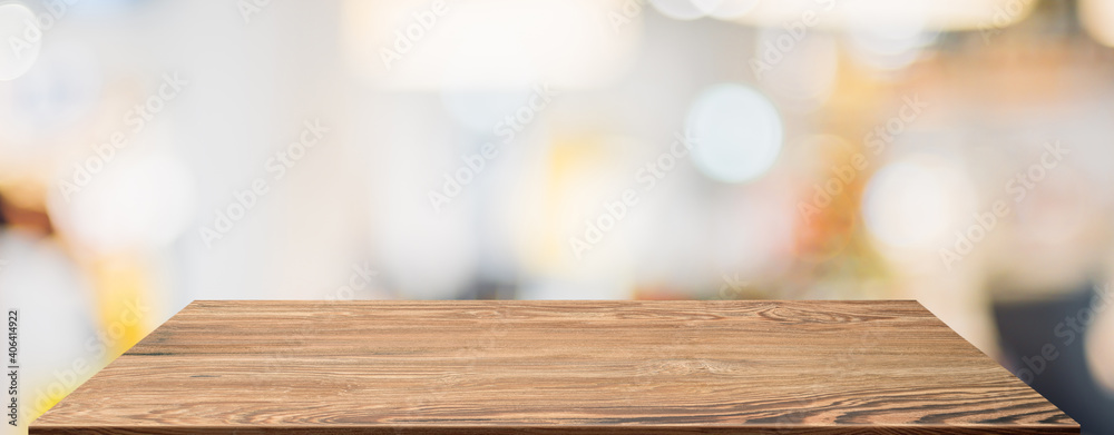 Aufkleber empty wood table with blur people in coffee shop background bokeh light and leaf foreground,mockup f