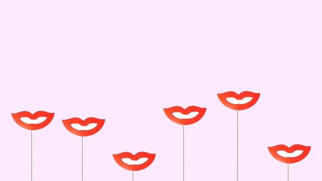 Stop motion animation snow-white smiles with red lips on sticks for a photo shoot move up and down on a pink background copy space