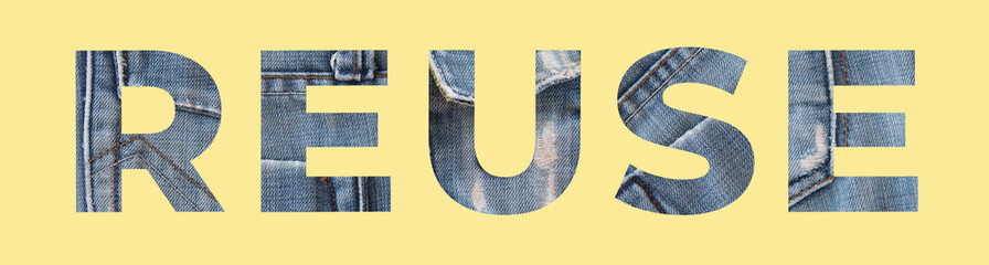 Reuse word from denim on yellow background. Recycle jeans concept