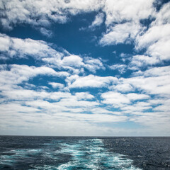 Naklejka na ściany i meble The waters ocean and the cloudy sky in a warm tropic of Atlantic ocean.