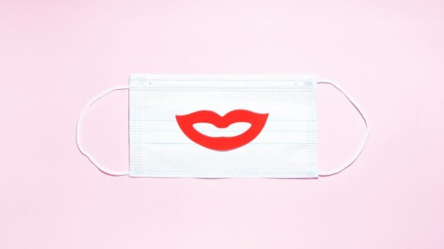 Stop motion animation Smile with red lips moves from left to right and increases in the center on a pink background kiss on valentines day and fools day