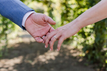 Close up of a married couple holding each others hands.