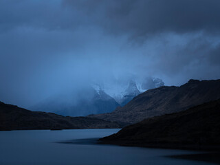 Torres del Paine peaks covered by clouds and fog in Patagonia