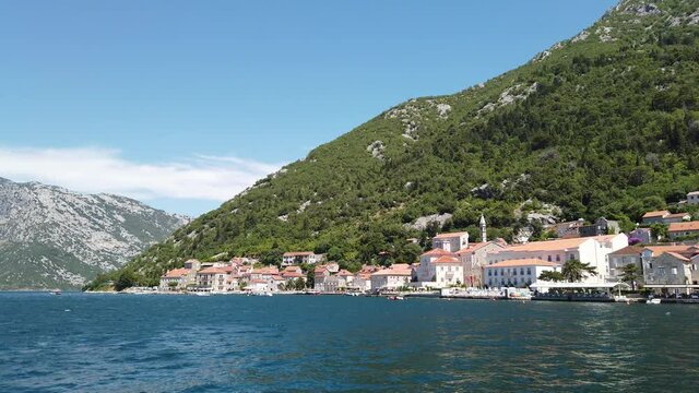Coastline of Perast, an old town on the bay of Kotor in Montenegro - Steadicam shot from the water