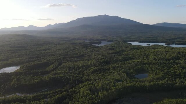 Revealing aerial shot of beautiful Mount Katahdin, forrests and lakes in Baxter State Park