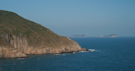 Sea waves splash against rock on island