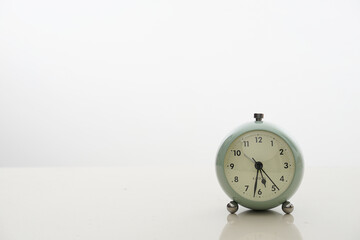 Alarm clock at wooden table with copy space 