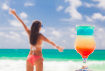 young woman on the beach with cocktail. Cayo Largo, Cuba