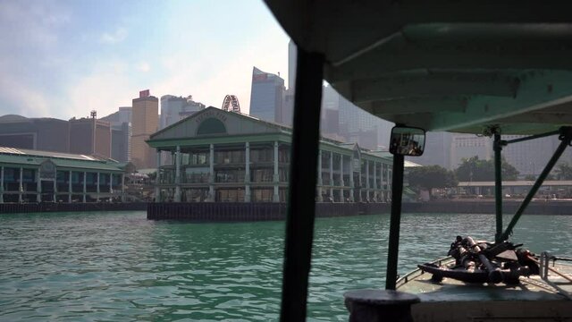 Ferry Boat Arriving at Pier on a Sunny Day in City of Hong Kong